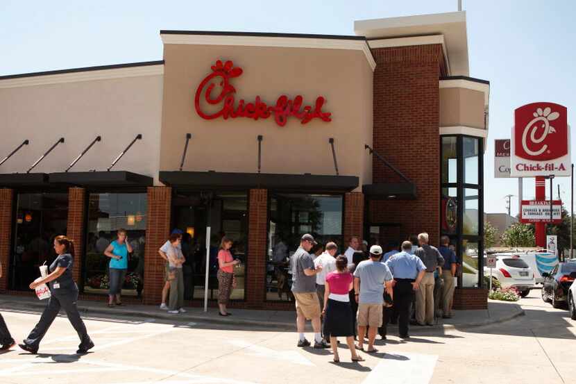 Customers waiting in line outside the Chick-Fil-A location at 7718 N. Central Expressway in...