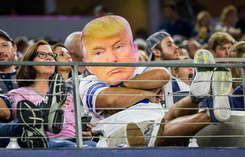 A Dallas Cowboys fan dressed as Donald Trump watches their game against the Philadelphia...