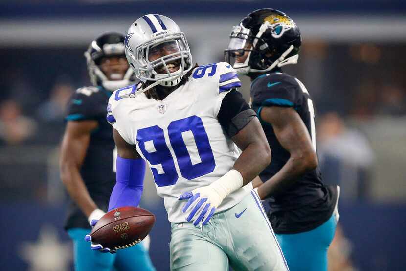 Dallas Cowboys defensive end Demarcus Lawrence (90) flashes a big smile after he helped...