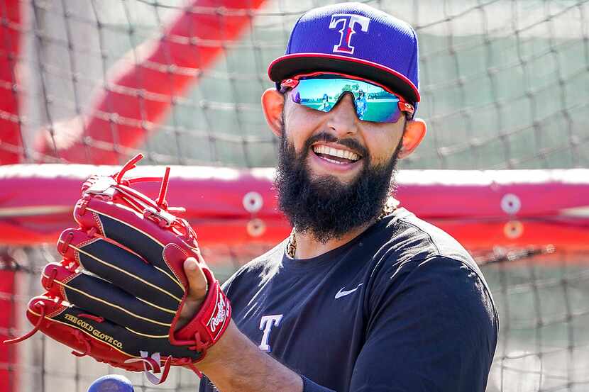 Texas Rangers second baseman Rougned Odor laughs with teammates during a spring training...