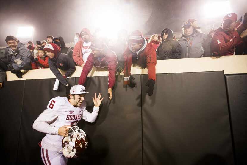 Oklahoma quarterback Baker Mayfield celebrates with fans following a 58-23 victory over...