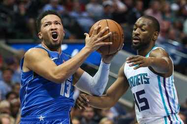 Dallas Mavericks guard Jalen Brunson (13) goes up for a shot past Charlotte Hornets guard...