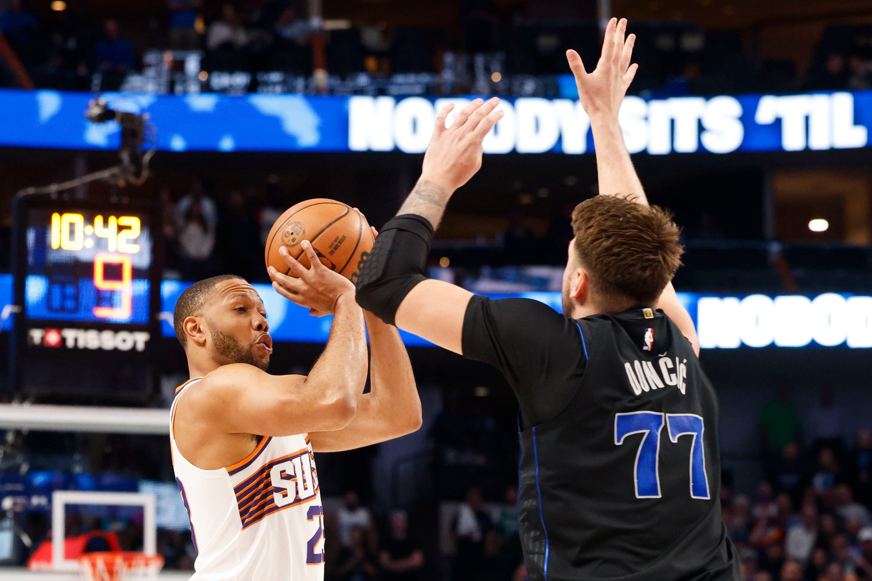 Phoenix Suns guard Eric Gordon (left) shoots over Dallas Mavericks guard Luka Doncic during...