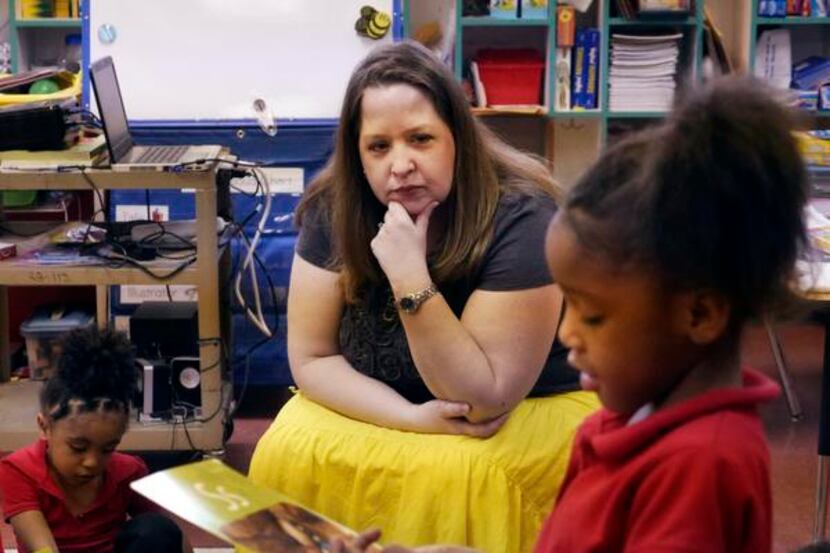 
DISD teacher Sara Tinsley watches Aurbrial Sterling, 5, study an alphabet card. Tinsley...