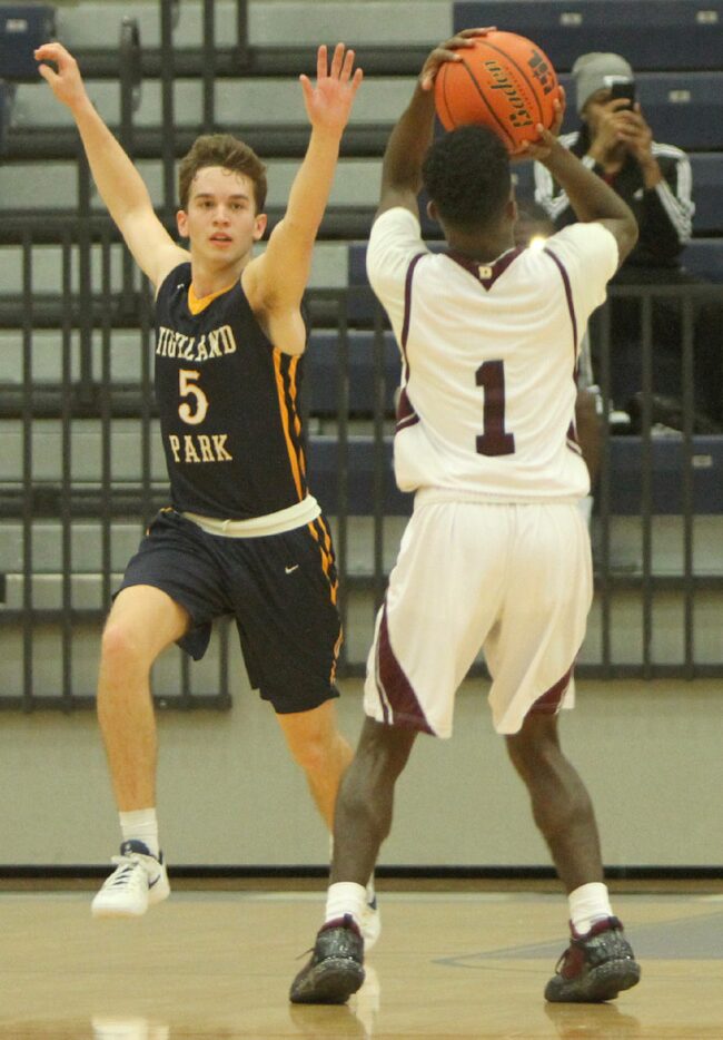 Despite the defense of Highland Park's Will Reichert (5), Rowlett's Joel Murray (1) launches...