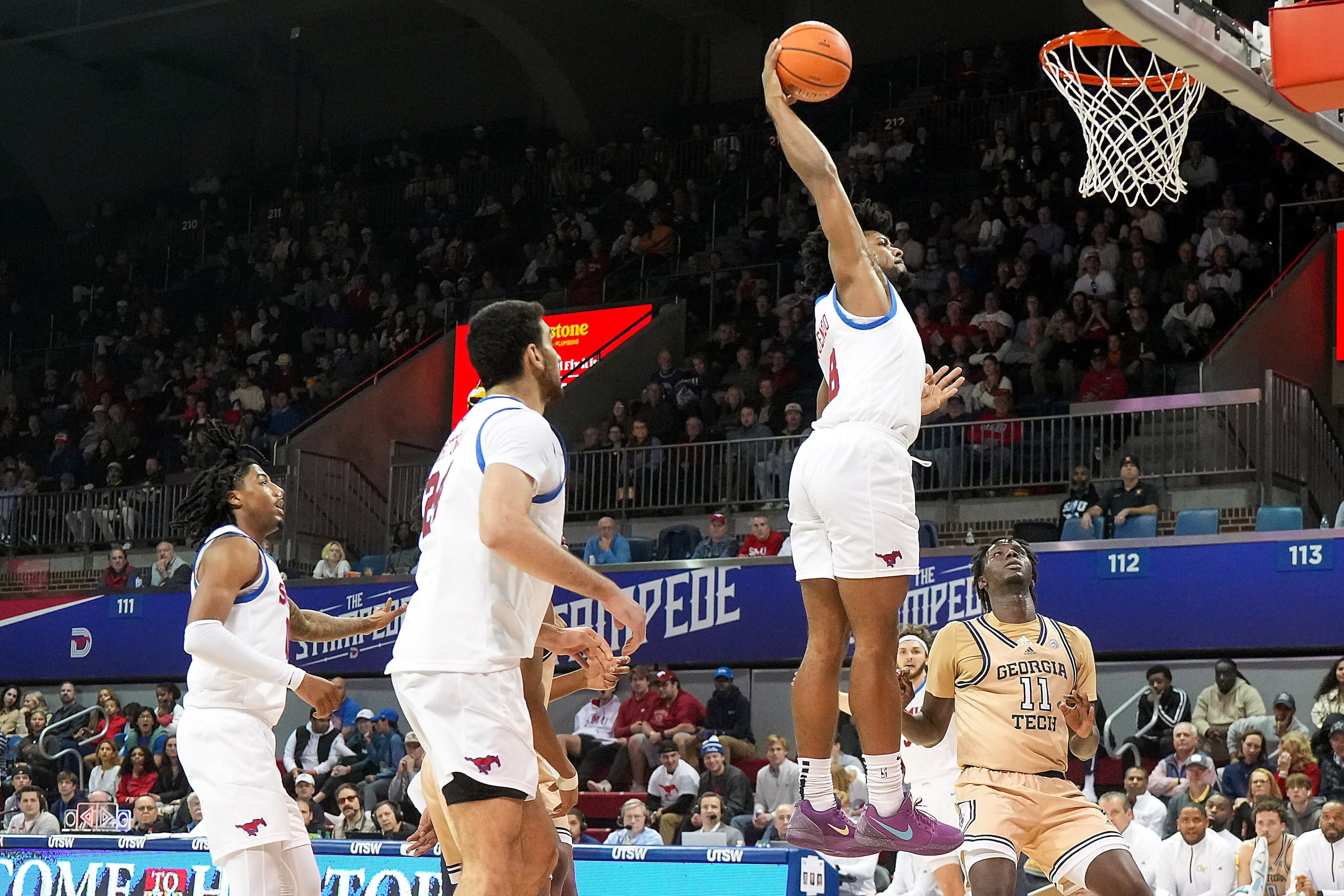 SMU guard Kario Oquendo (8) dunks the ball over Georgia Tech forward Baye Ndongo (11) during...