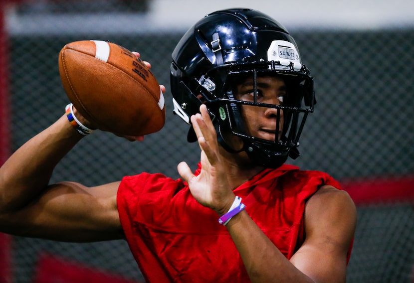 Euless Trinity senior running back and quarterback Ollie Gordon throws during a varsity...