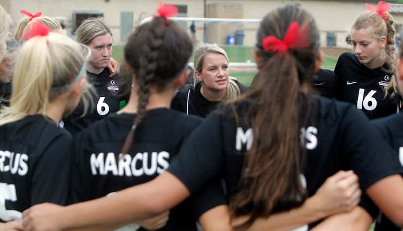 Flower Mound Marcus head coach Erin Hebert, center, speaks with her players just prior to...