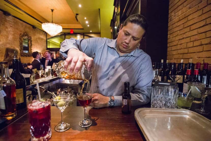 Co-owner Adam Salazar pours cocktails at The Mitchell, a restaurant and cocktail bar, on...