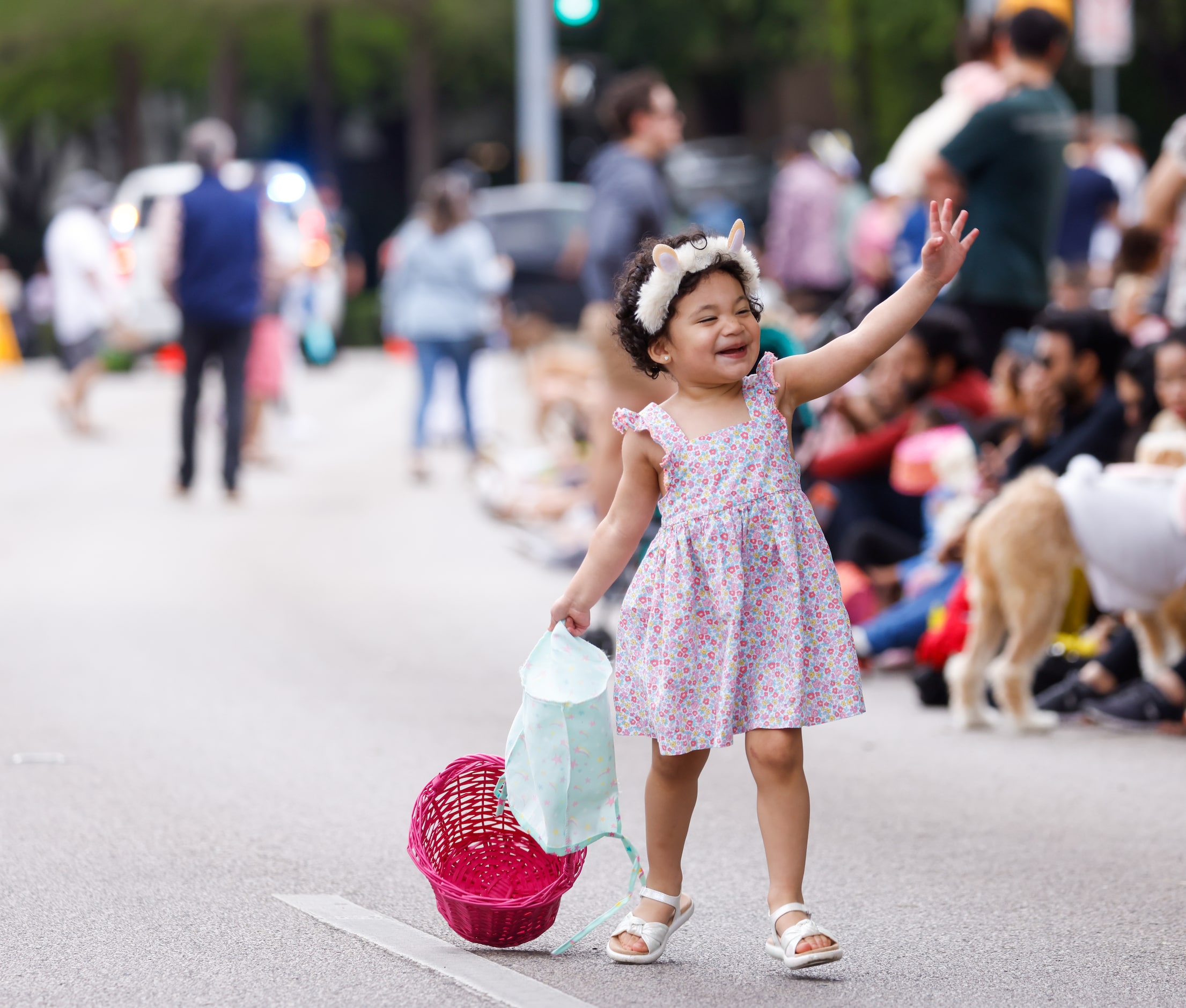 Zayda Makki, 2, drags an Easter basket behind her in the open space dedicated as a runway...