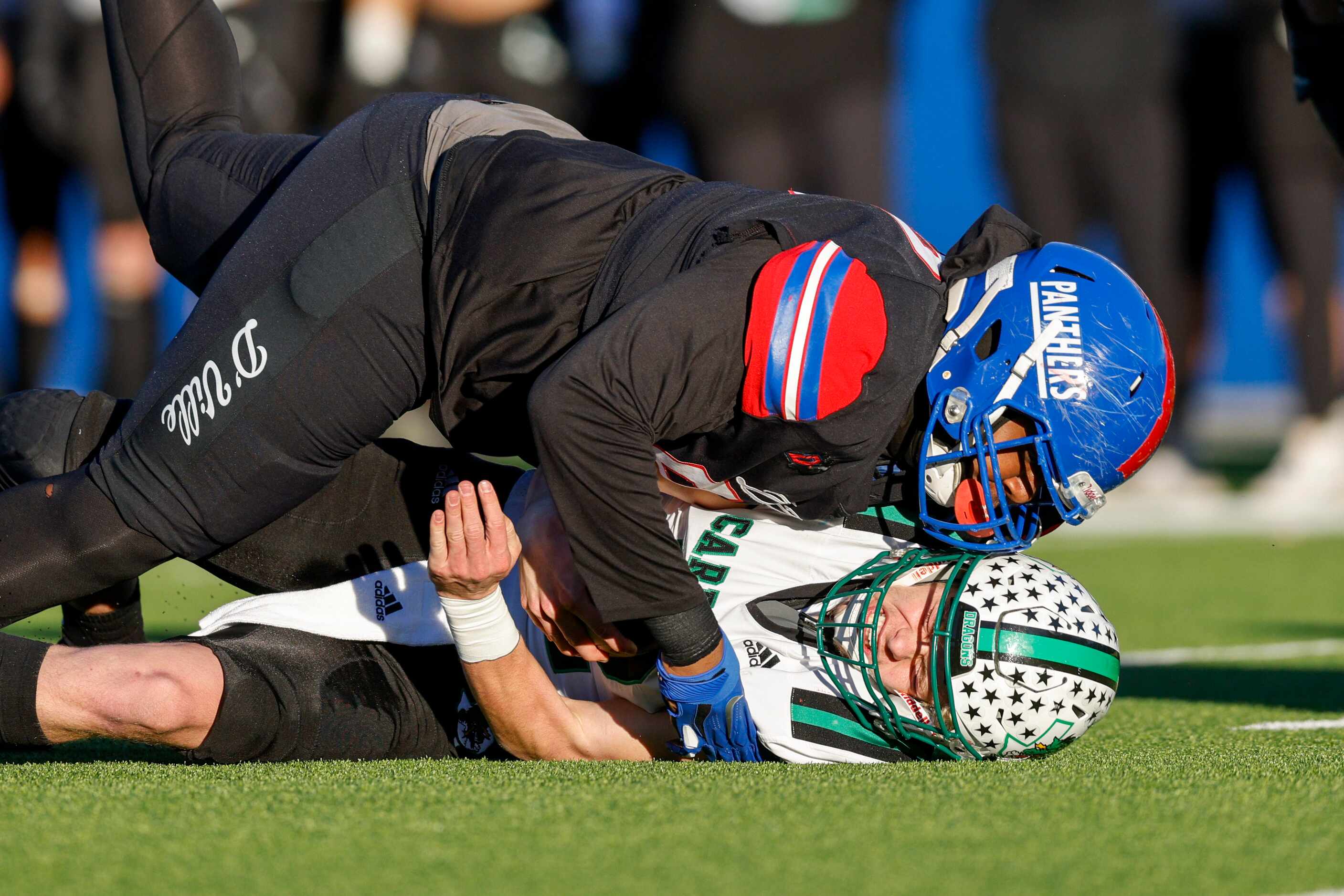 Duncanville defensive lineman Alex January (99) tackles Southlake Carroll quarterback Kaden...