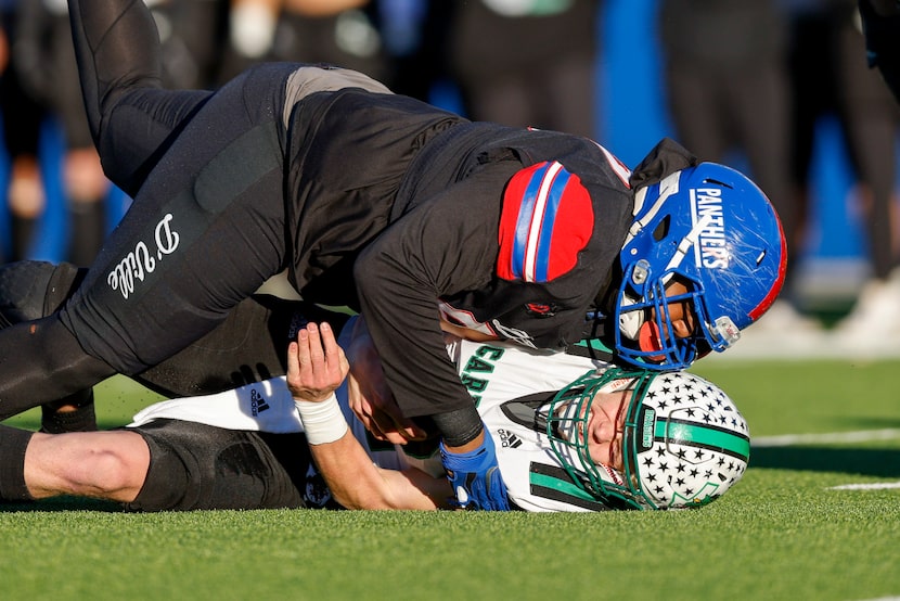 Duncanville defensive lineman Alex January (99) tackles Southlake Carroll quarterback Kaden...