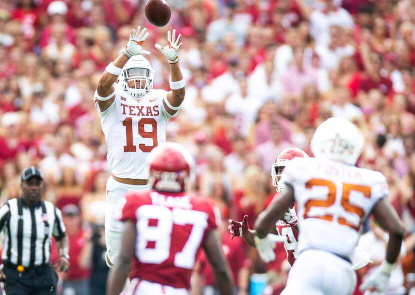 Texas defensive back Brandon Jones (19) intercepts a pass intended for Oklahoma wide...