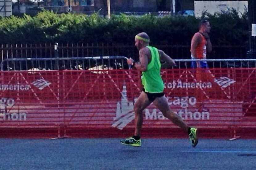 Nearing the finish of the Chicago Marathon, Randy Bobe is still running at full stride. Look...
