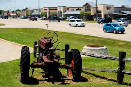 An old tractor is a reminder of yesteryear, displayed along Hwy. 380 in the retail strip...