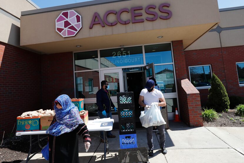 Workers at ACCESS, the Arab Community Center for Economic and Social Services, help with...