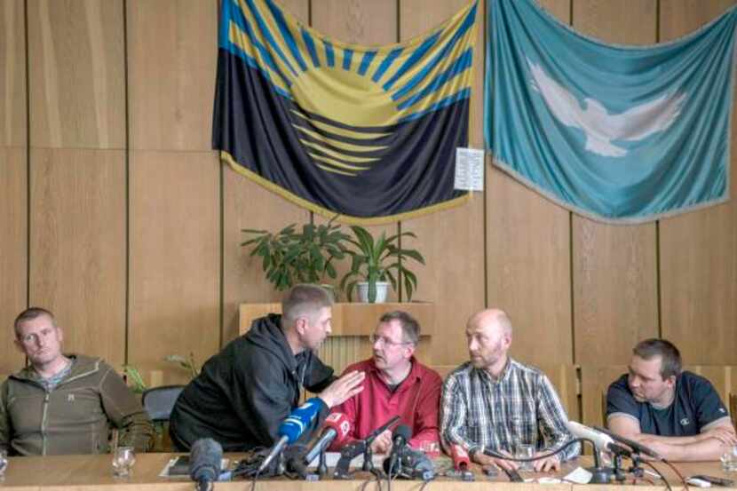 
Vyacheslav Ponomariov (second from left), the self-appointed mayor of Slovyansk, speaks...