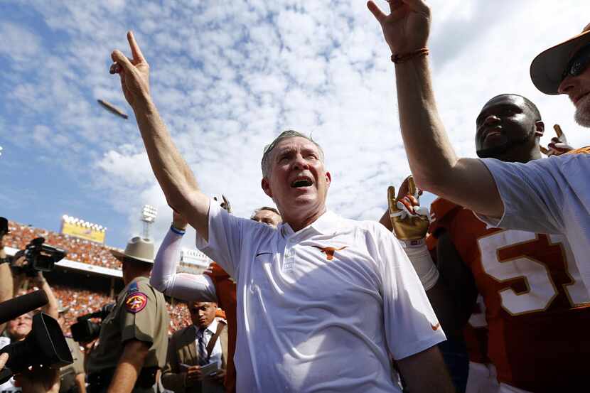 Texas head coach Mack Brown sings the school song after beating Oklahoma in the Red River...