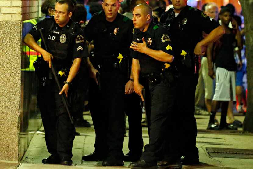 Dallas police officers prepared to enter a parking garage during the ambush July 7. Five...