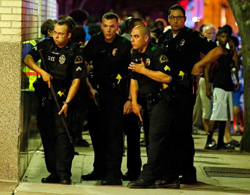 Police officers ran with guns drawn into a parking garage during the ambush on July 7.