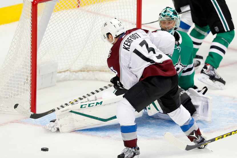 Colorado Avalanche center Alexander Kerfoot (13) recovers a rebound before scoring against...