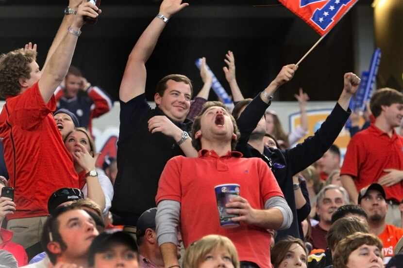 Ole Miss fans celebrate an Olahoma State turnover in the fourth quarter in the Ole Miss vs....