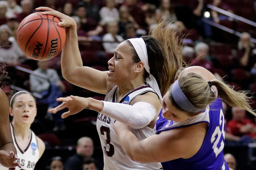 Texas A&M's Chennedy Carter (3) is fouled by Drake's Hannah Fuller (22) during the second...