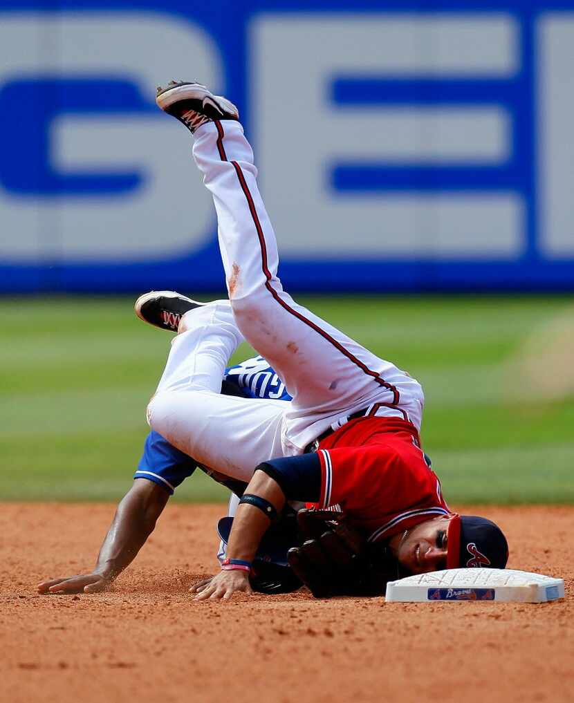  Martin Prado #14 of the Atlanta Braves is upended at second base by Jose Guillen #6 of the...