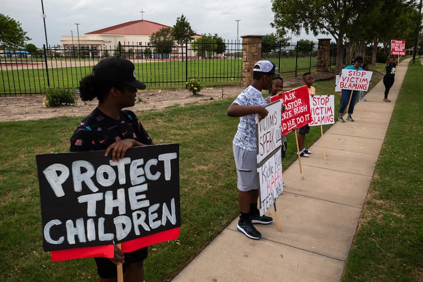Protestors held signs and chanted outside Inspiring Body of Christ Church in Dallas on April...