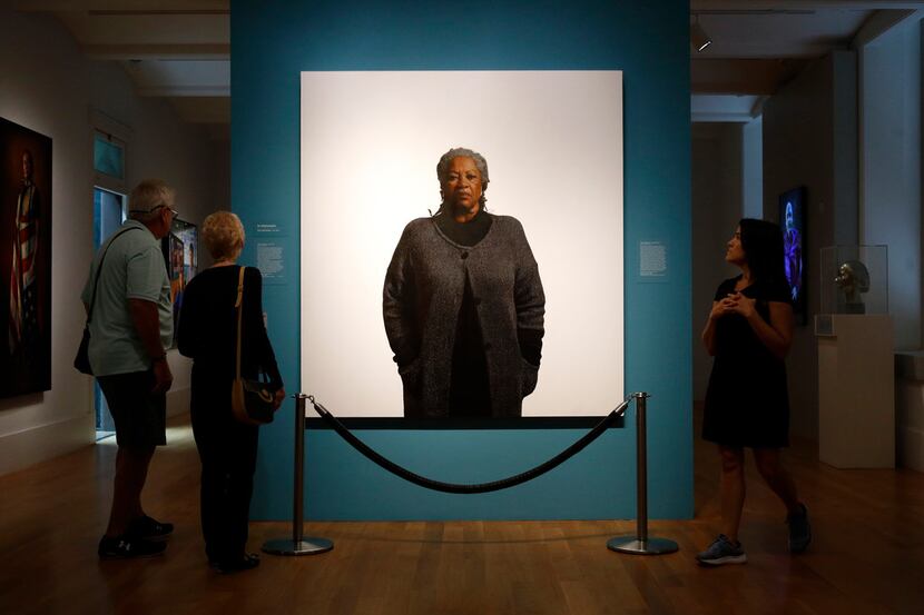 Visitors view a portrait of Toni Morrison by the artist Robert McCurdy, on Aug. 6, 2019, at...