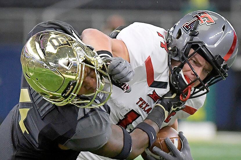 Texas Tech Red Raiders wide receiver Dylan Cantrell (14) stiff-arms Baylor Bears cornerback...