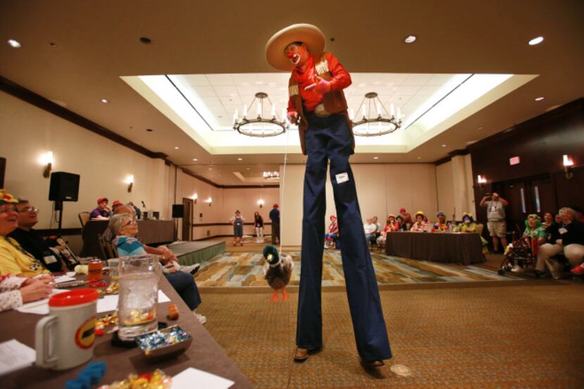 David McCullough of Tyler walks in stilts in character as "KornPop" the clown for judges at...