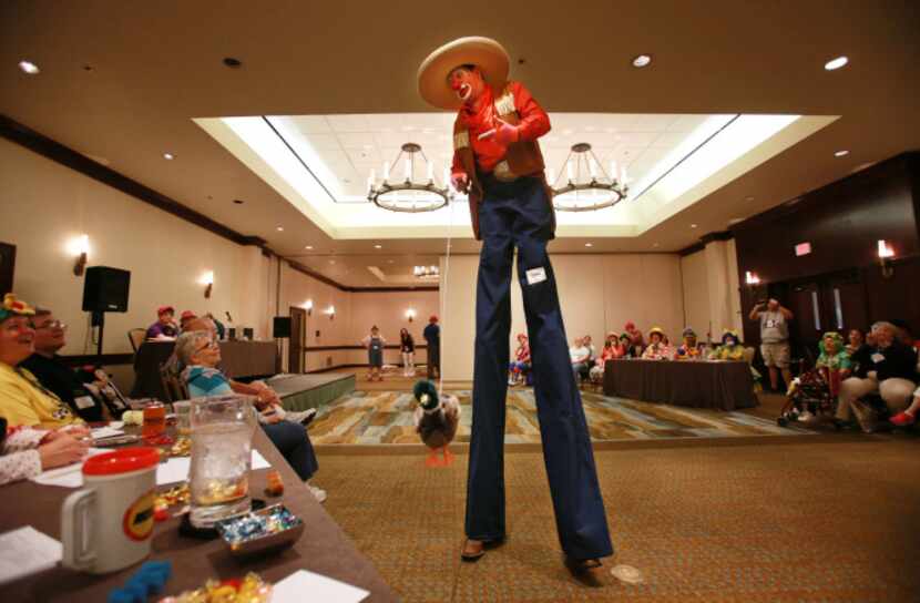 David McCullough of Tyler walks in stilts in character as "KornPop" the clown for judges at...