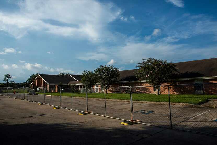 A fence surrounds the vacant Cypress Glen nursing home on Monday in Port Arthur.  The Texas...