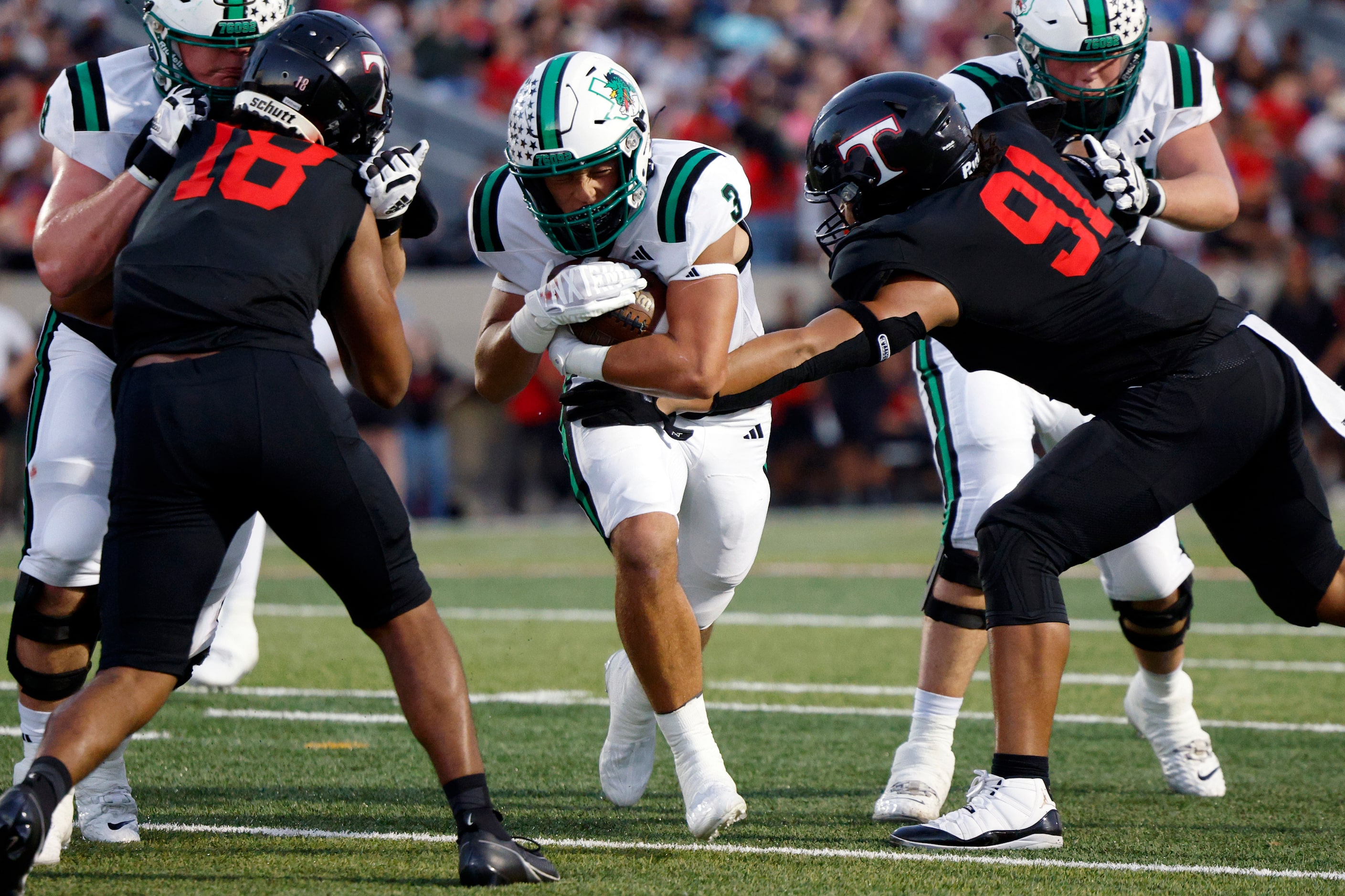 Southlake Carroll running back Davis Penn (3) runs through the arms of Euless Trinity...