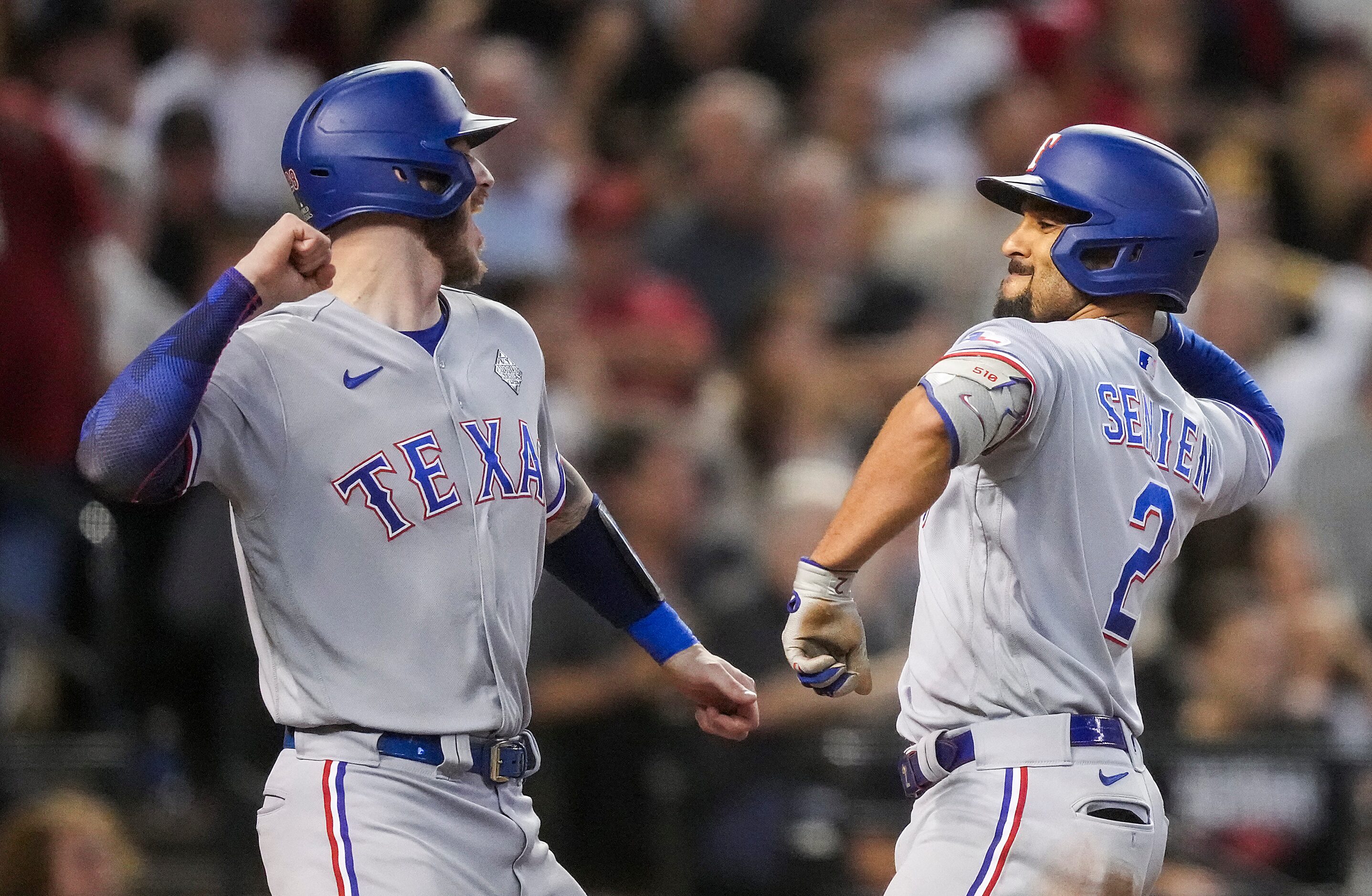 Texas Rangers second baseman Marcus Semien celebrates with Jonah Heim (left) after hitting a...