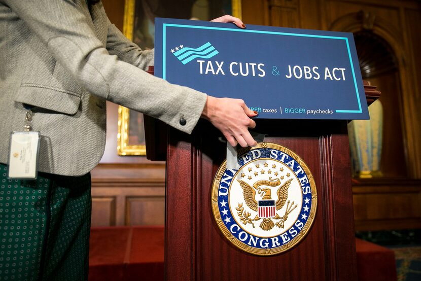 Paige Waltz, on House Speaker Paul Ryan's staff, prepares a podium for a news conference at...