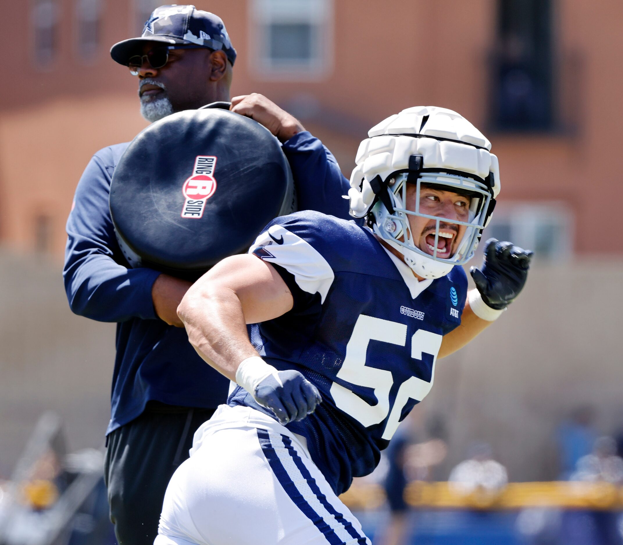 Dallas Cowboys defensive end Mike Tafua (52) runs through pass rush drills during training...