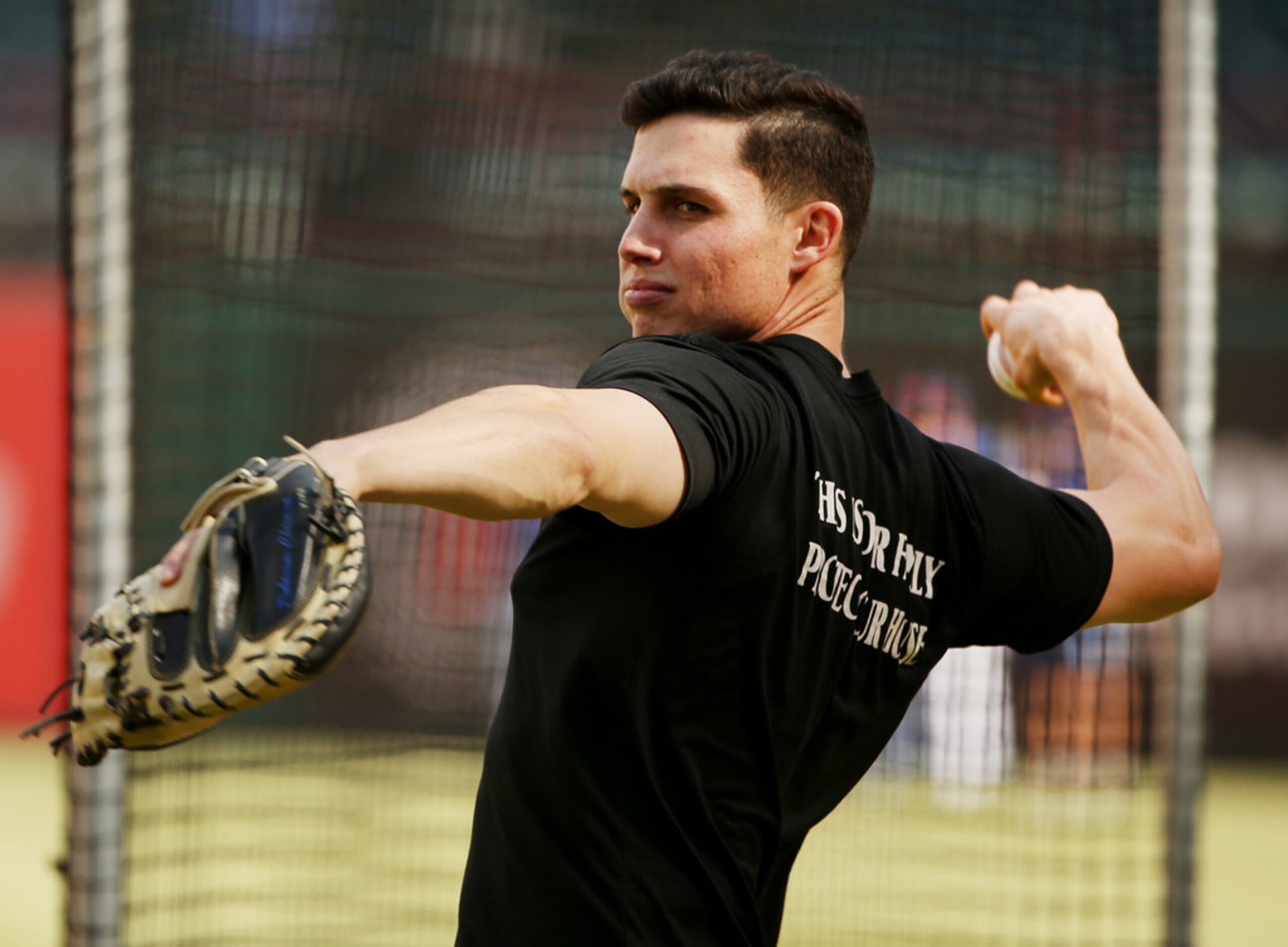 Texas Rangers outfielder Drew Robinson (18) tosses the ball during batting practice before a...