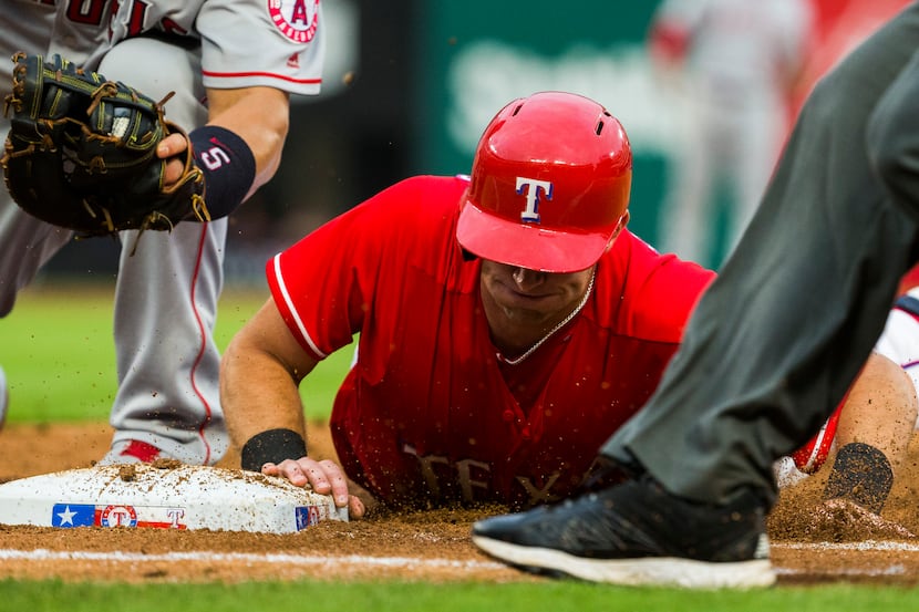 Texas Rangers center fielder Jared Hoying (36) makes it back to first base before he can be...