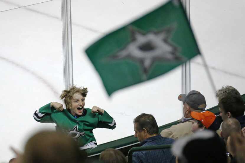 A young Dallas fan gets excited during the action in the third period during the Calgary...