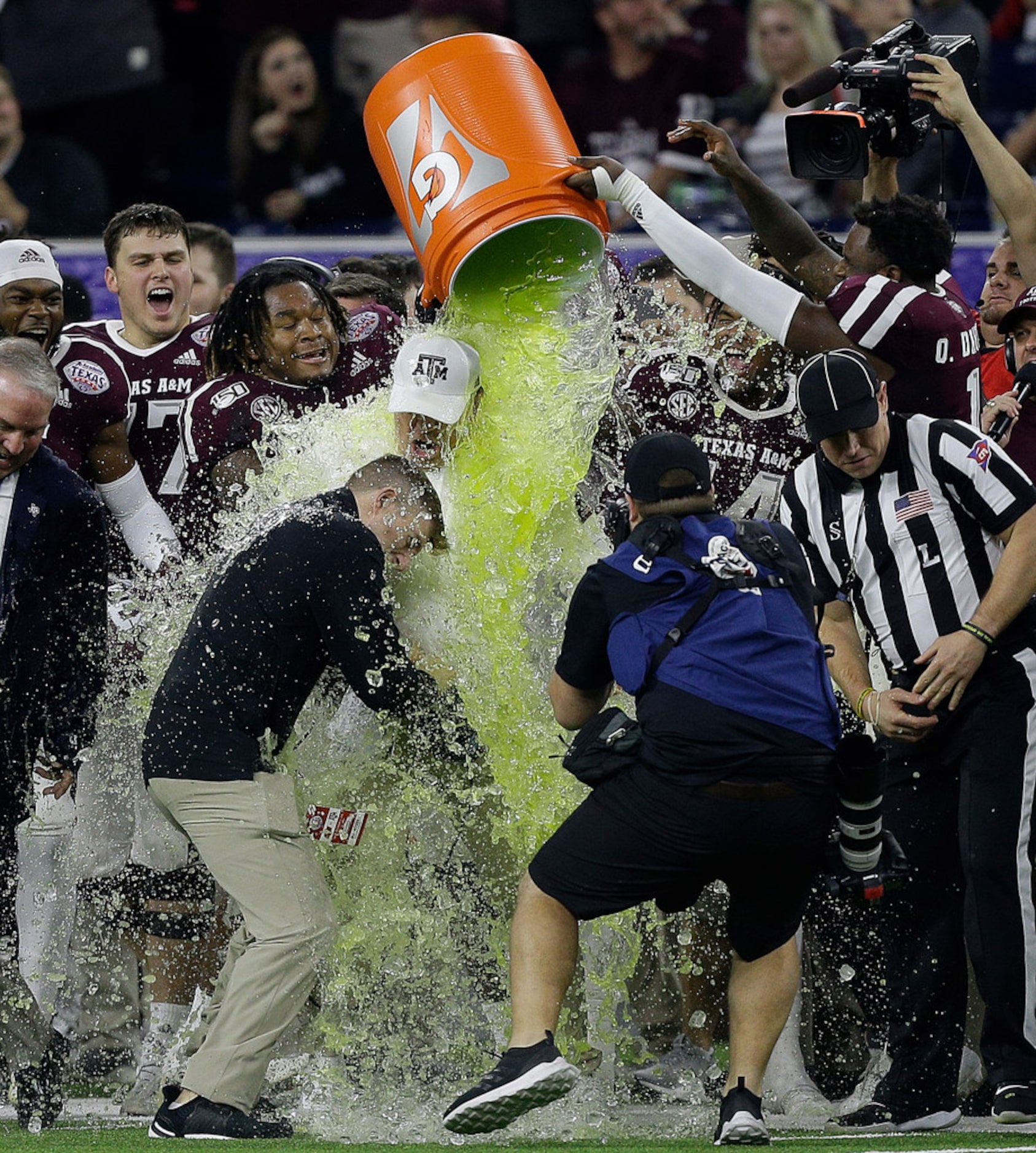 HOUSTON, TEXAS - DECEMBER 27: Head coach Jimbo Fisher of the Texas A&M Aggies receives a...