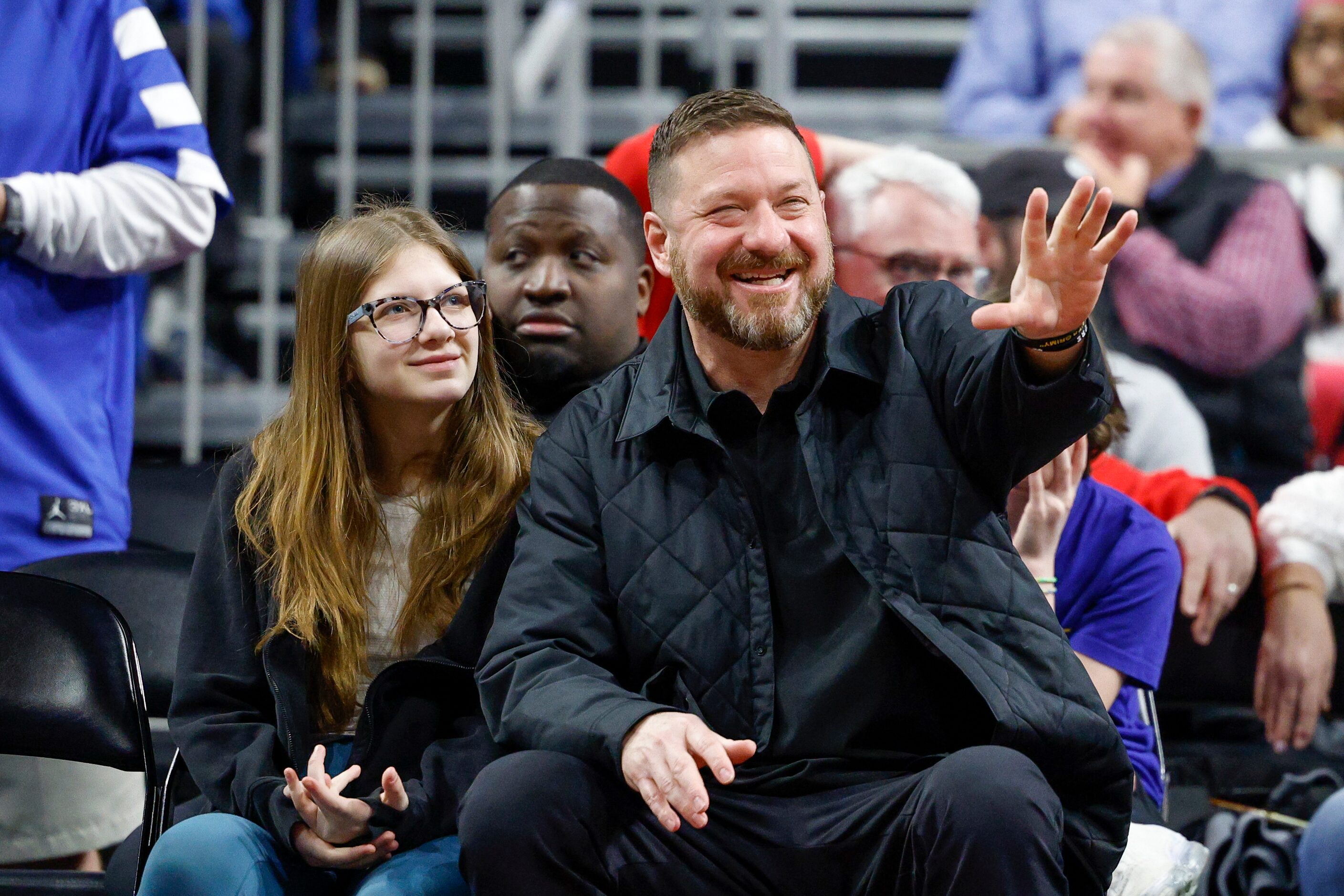 Texas men’s basketball head coach Chris Beard waves alongside his daughter Margo Beard...