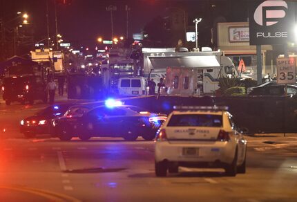  Lights from police vehicles light up the scene in front of the Pulse club in Orlando,...