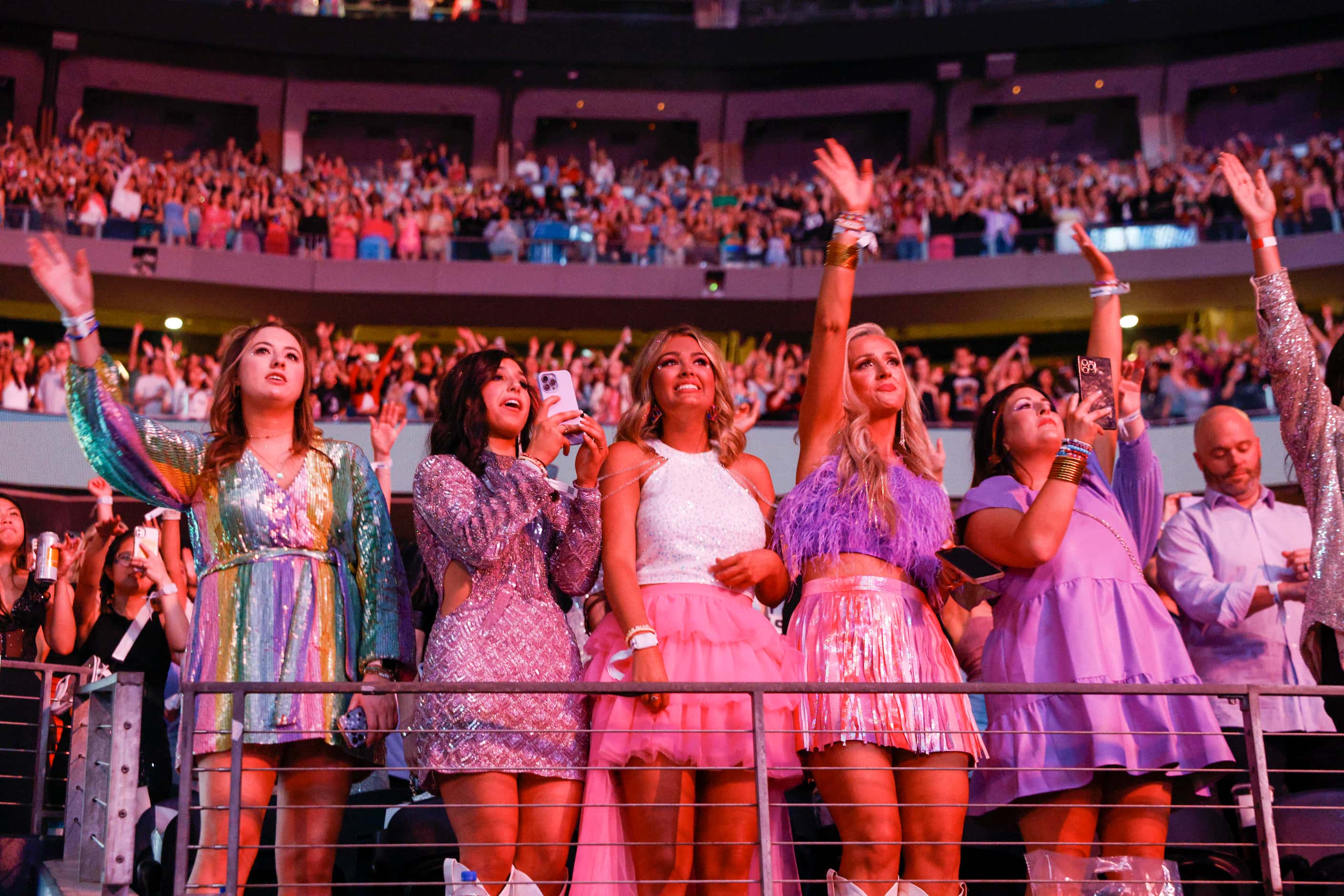 Fans watch and cheer as Taylor Swift performs during the Eras Tour concert at AT&T Stadium...