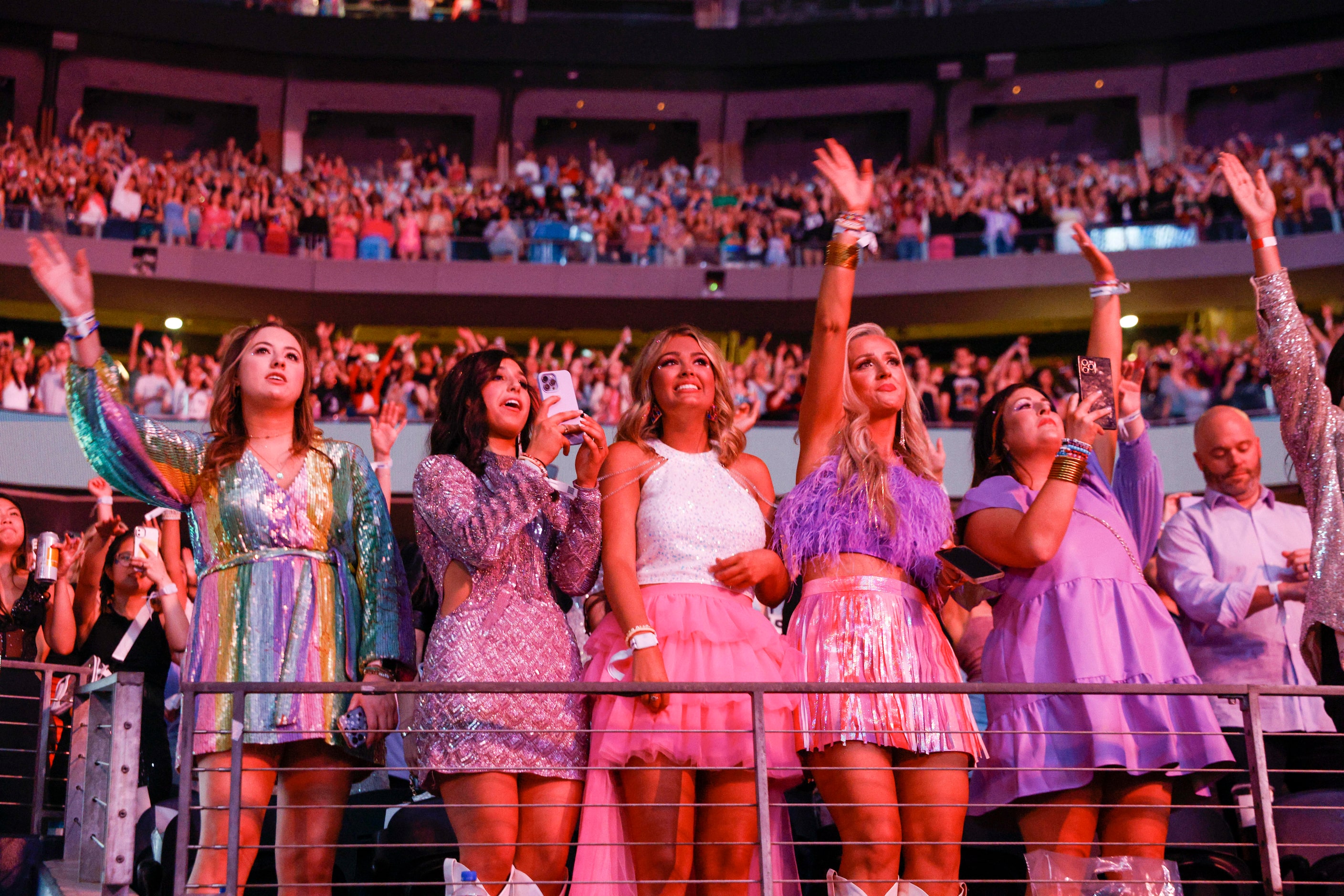 Fans watch and cheer as Taylor Swift performs during the Eras Tour concert at AT&T Stadium...