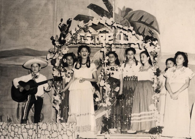 Nine-year-old Trini Lopez (left) accompanies his sister, Lucy Martinez Lopez (center) during...