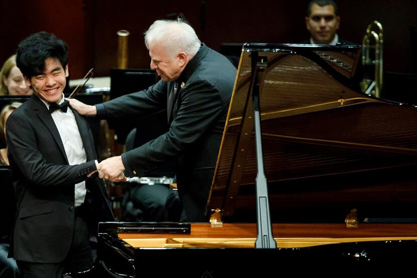 Daniel Hsu of the USA is congratulated by conductor Leonard Slatkin after performing a piano...