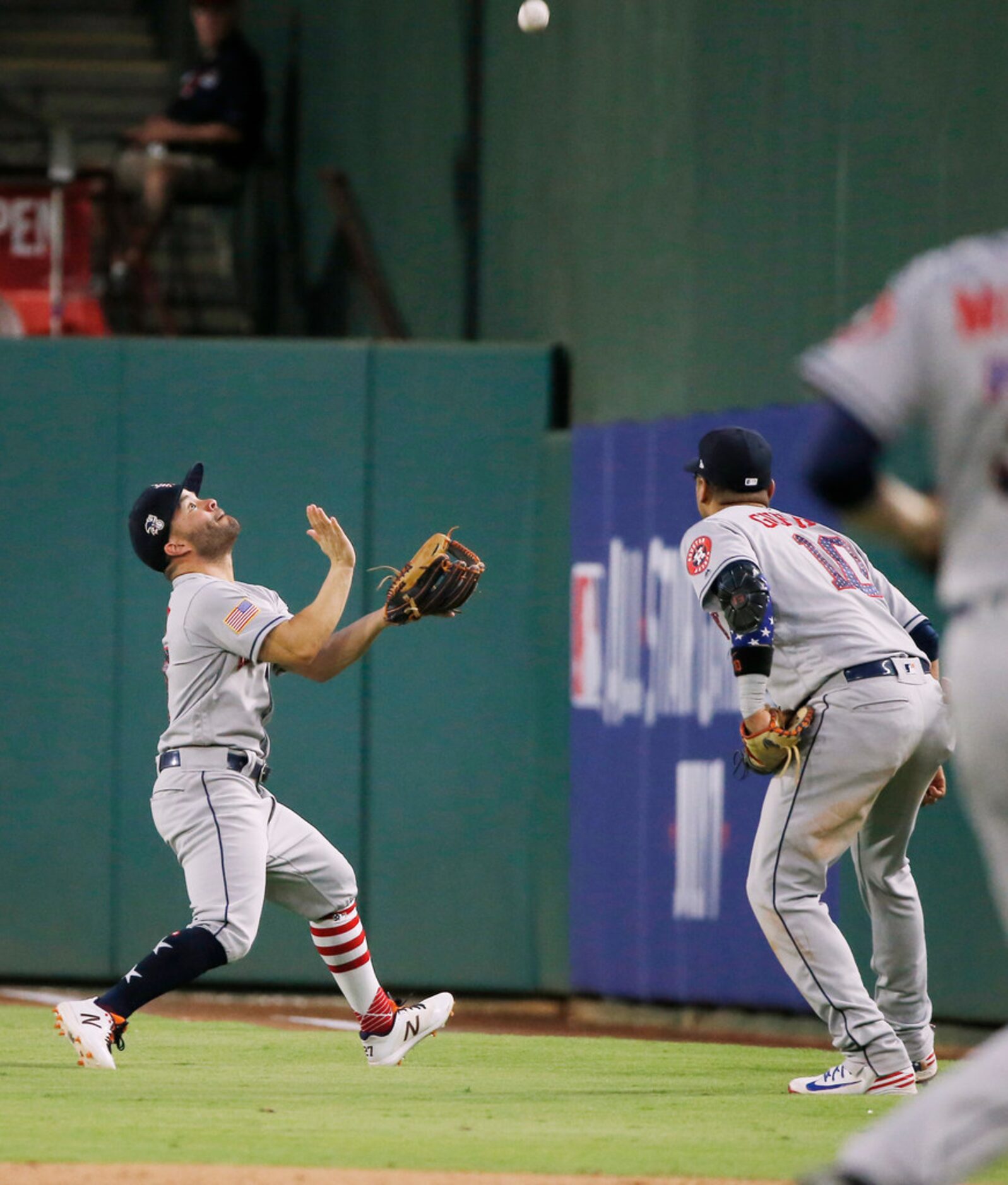 Houston Astros first baseman Yuli Gurriel (10) watches as second baseman Jose Altuve (27)...