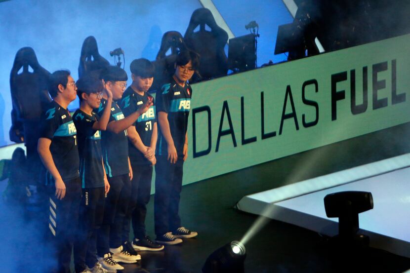 Dallas Fuel team members greet cheering fans prior to the start of their match against...